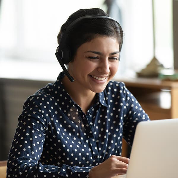 Woman with her headset on her laptop.