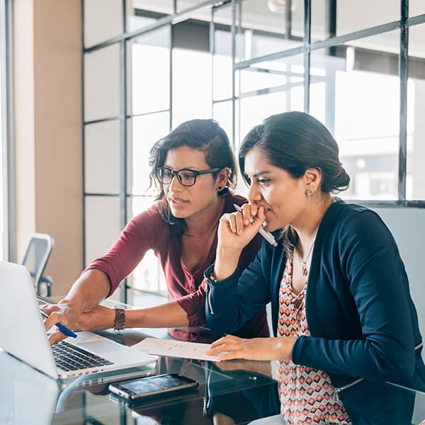 2 employees working at a desk.