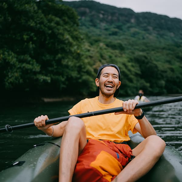 Young man kayaking in a lake.