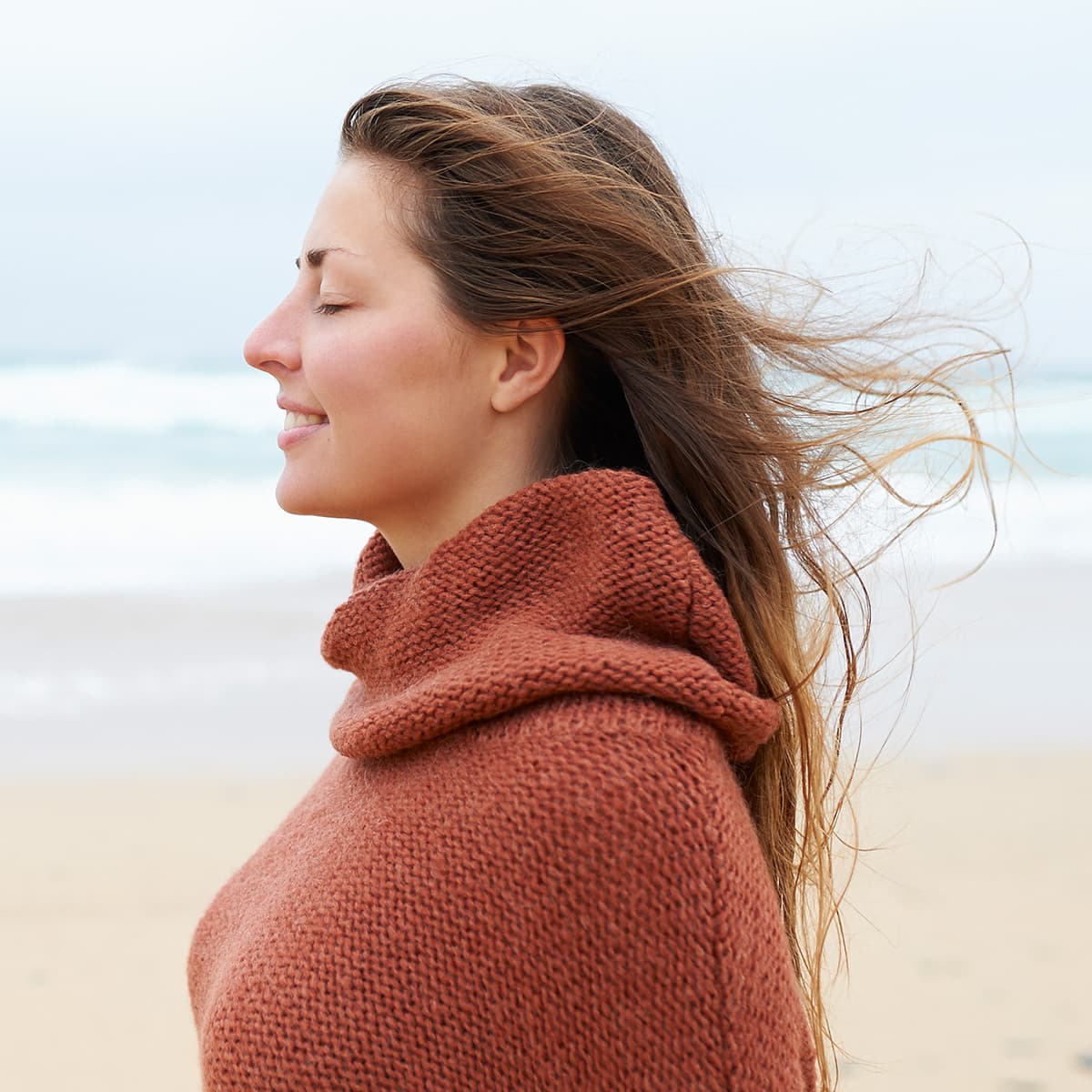 Woman smiling on the beach.