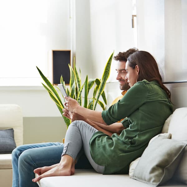 Man and woman sitting on a couch.