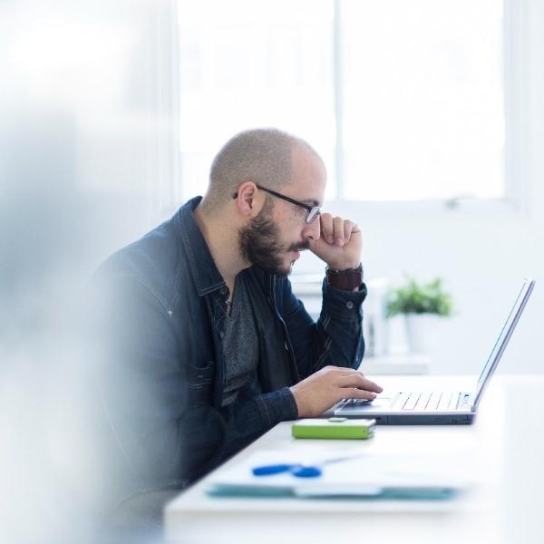 Man reading insurance policy document online.