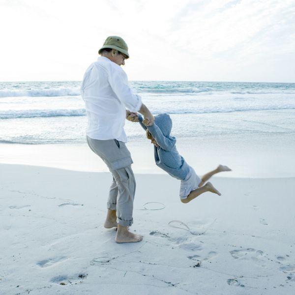 Father and kid at the beach.