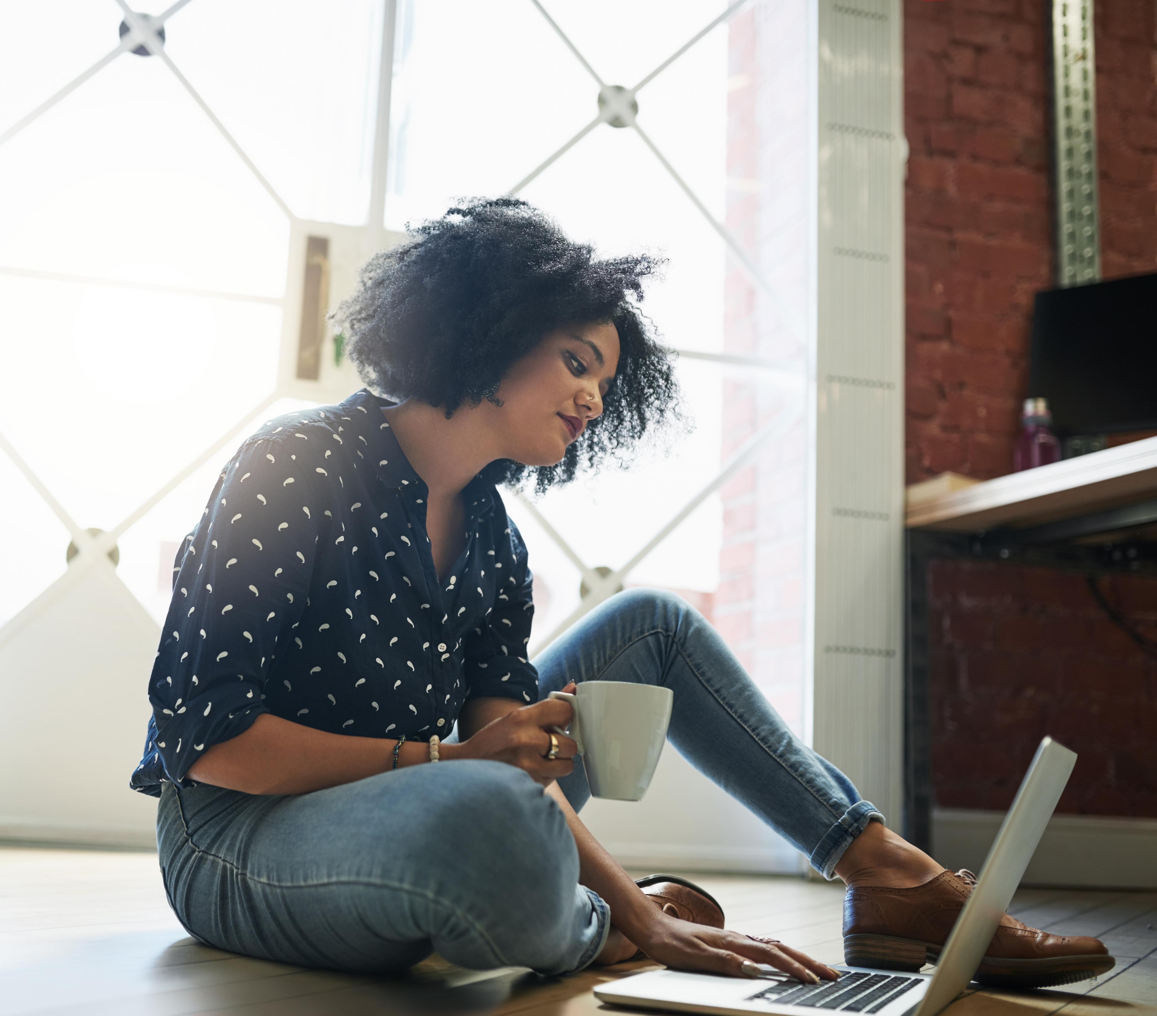 Woman reading about disability insurance on laptop.