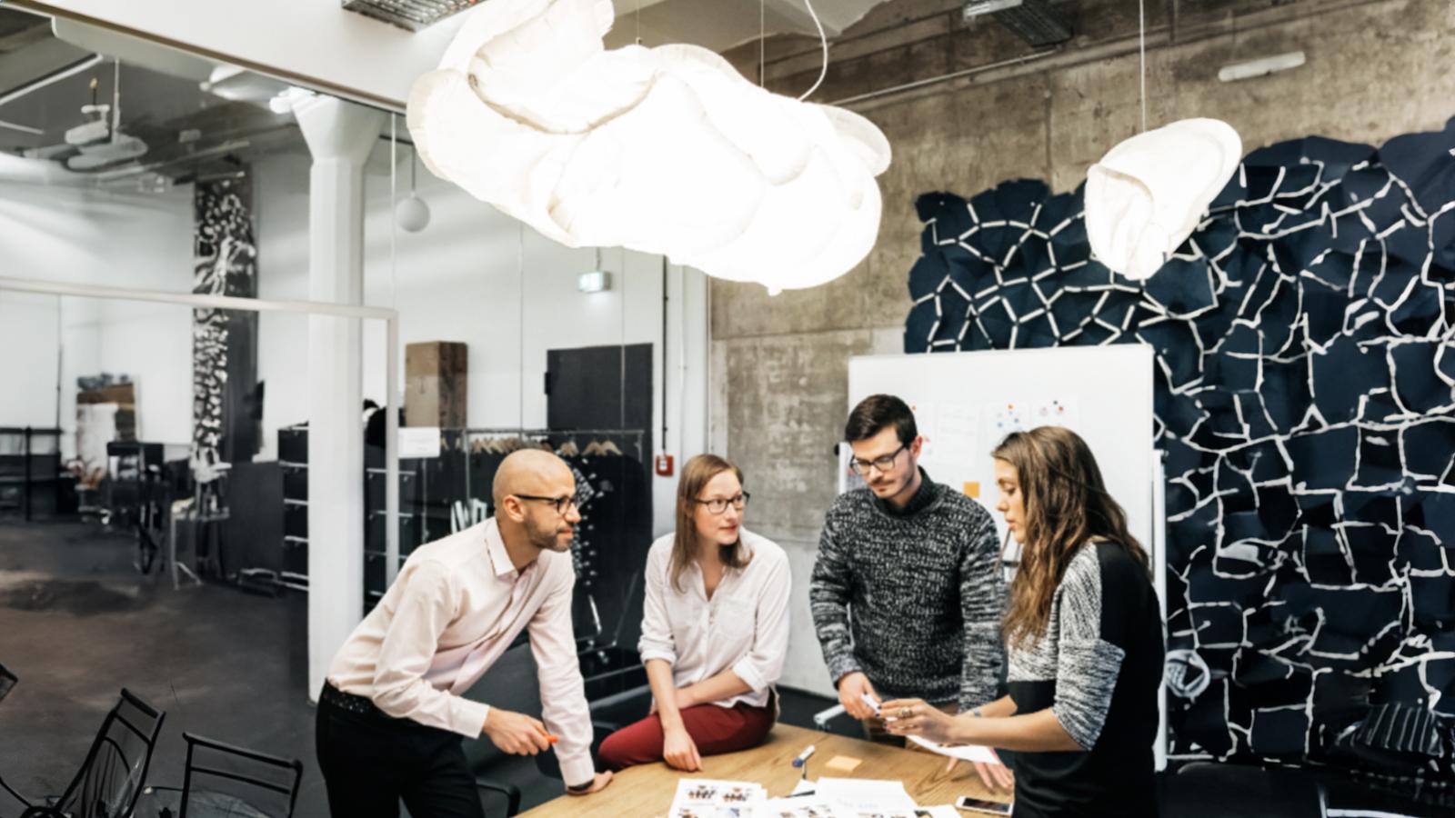 group-of-employees-looking-over-paperwork