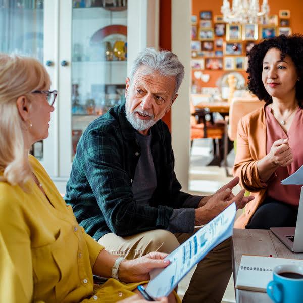 Elderly couple in a discussion with their financial professional.