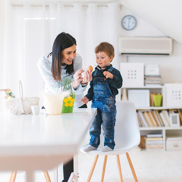Mother and son painting an egg