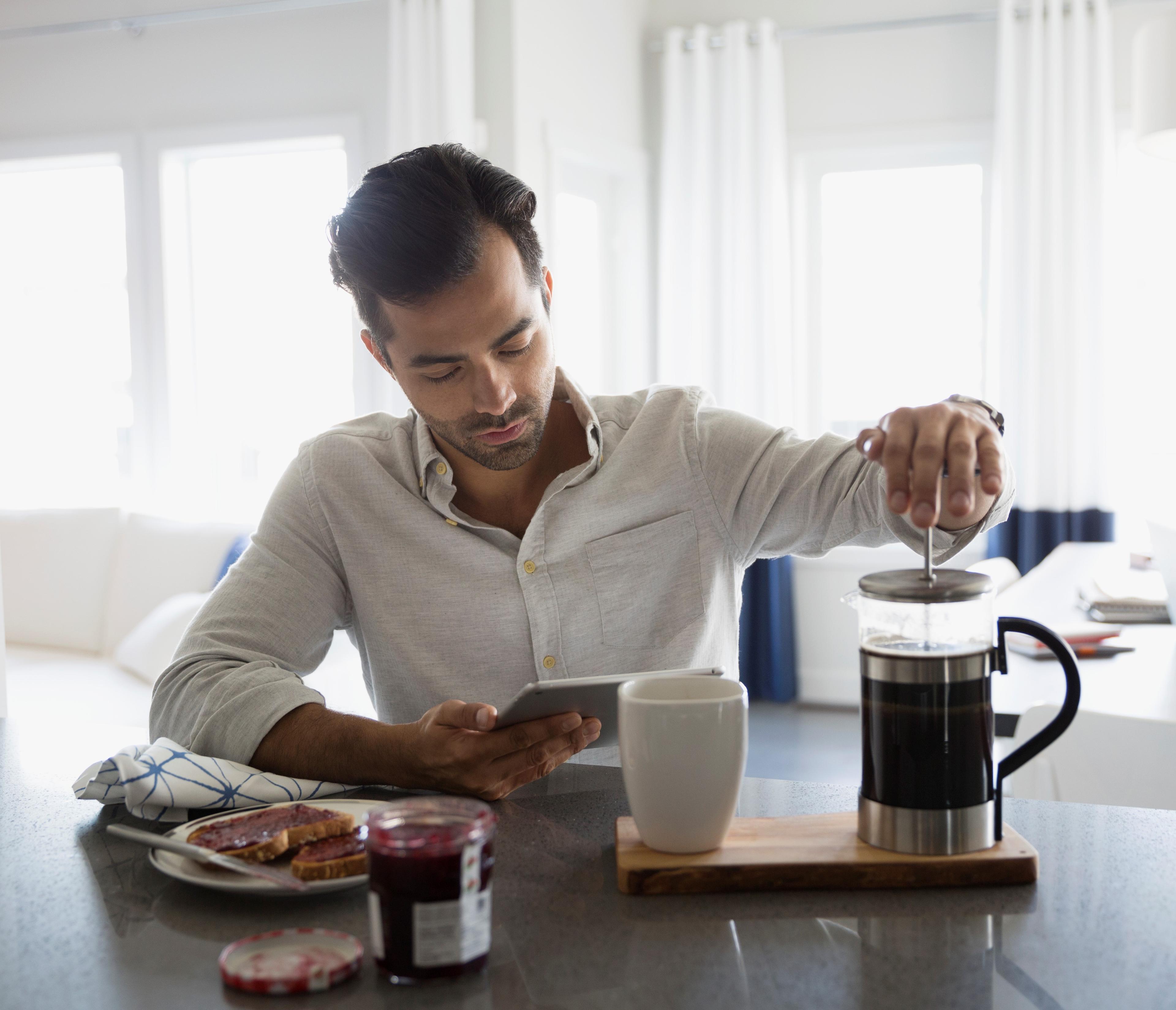 Man reading on table device about disability insurance.