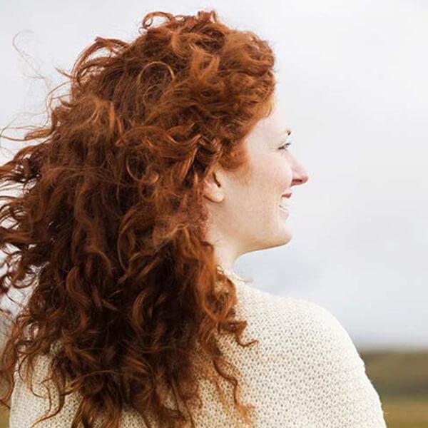 Woman with curly red hair.