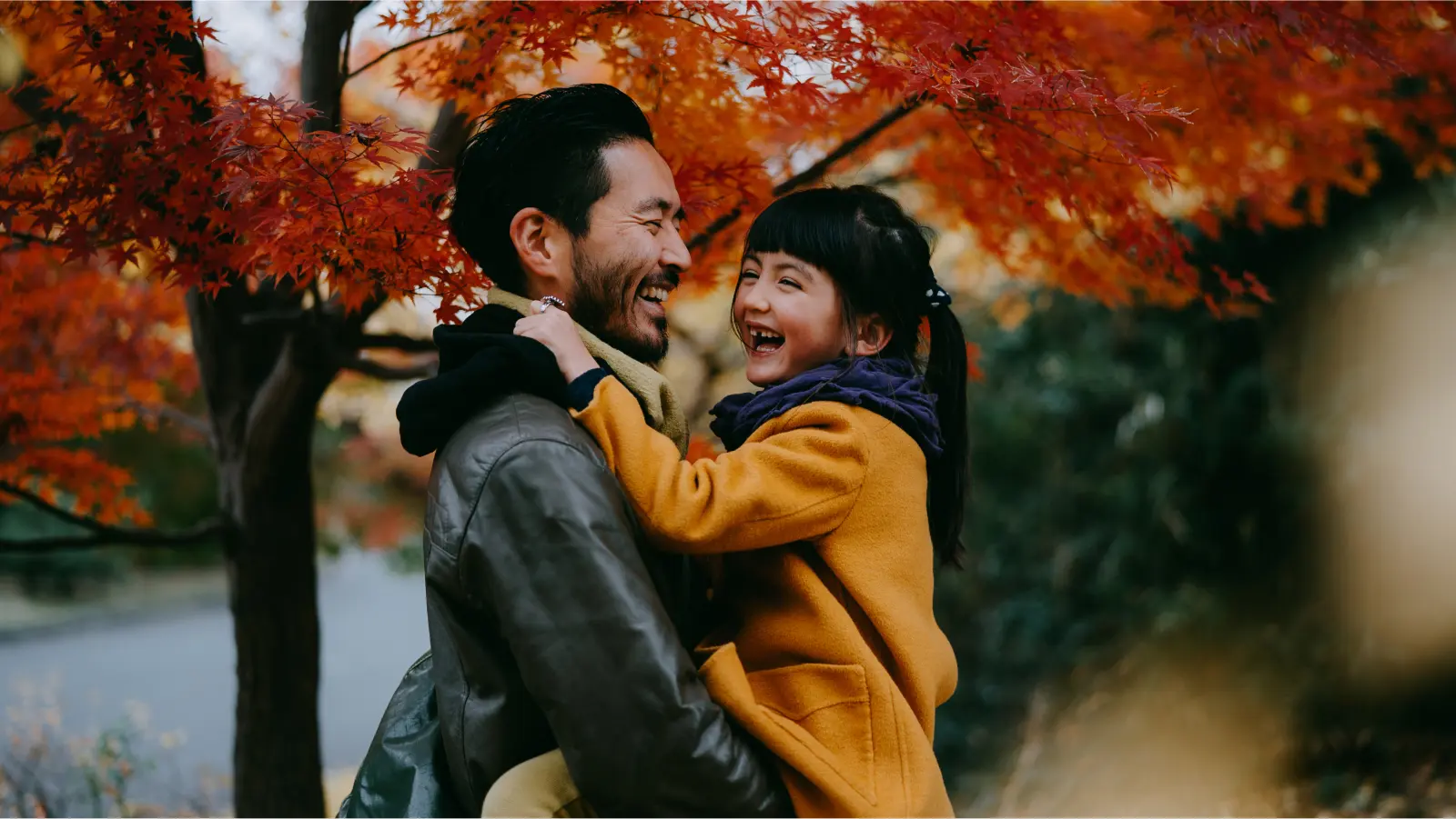 Dad holding daughter during fall