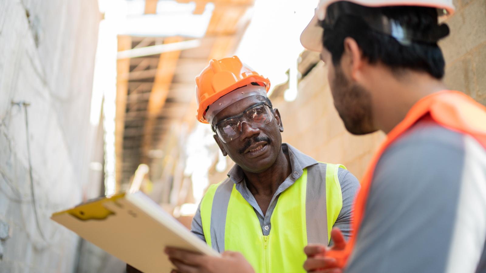 Two construction workers talking to each other Two construction workers talking to each other