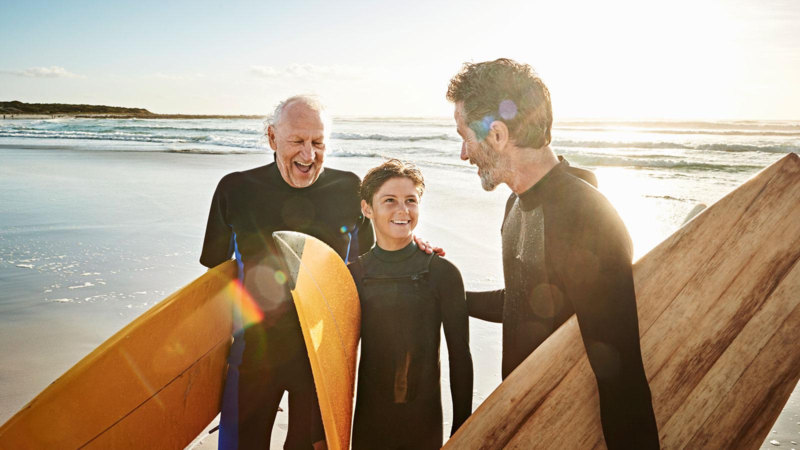 Grandfather, father and son surfing