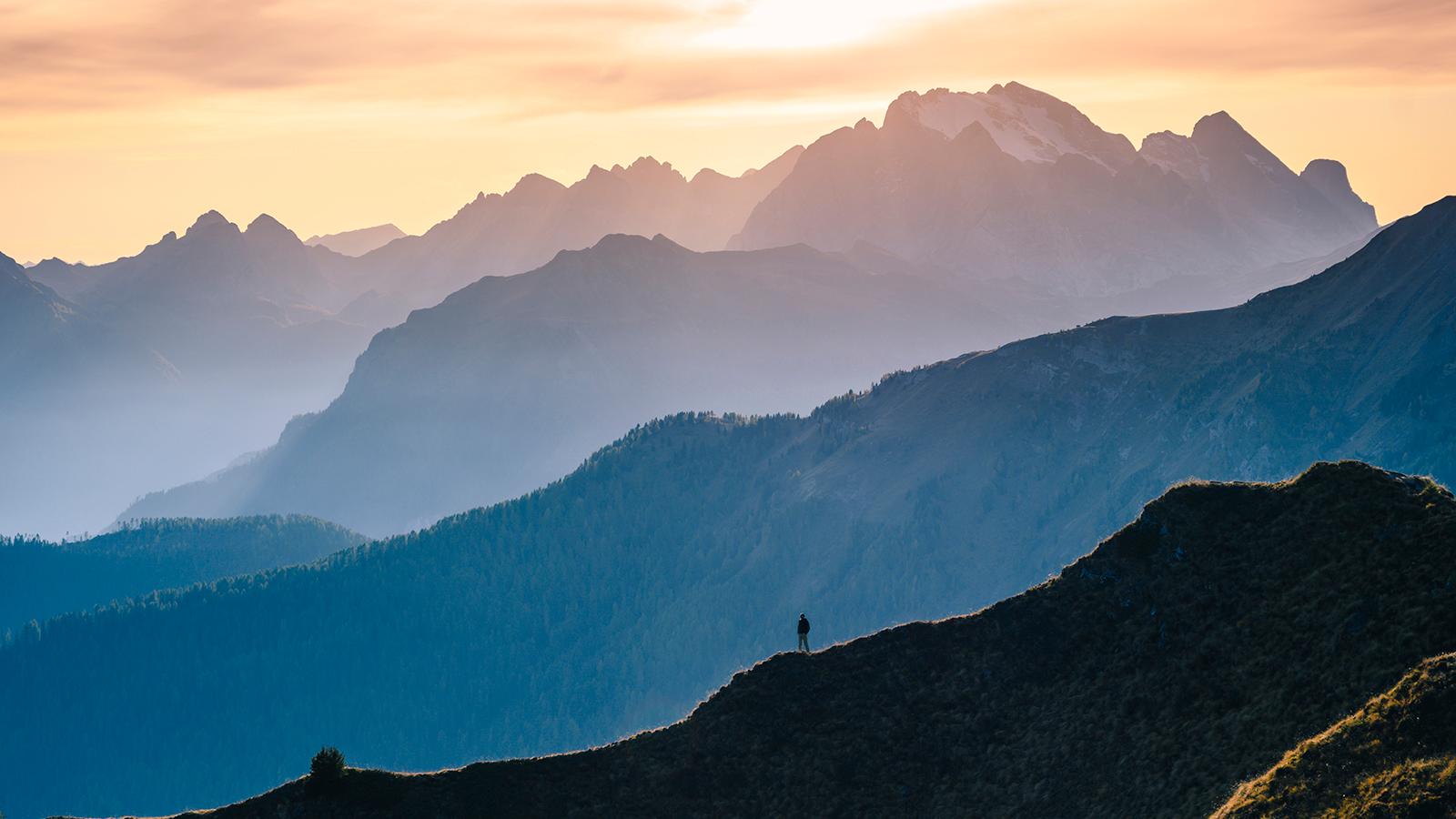 Man standing at the top of a mountain