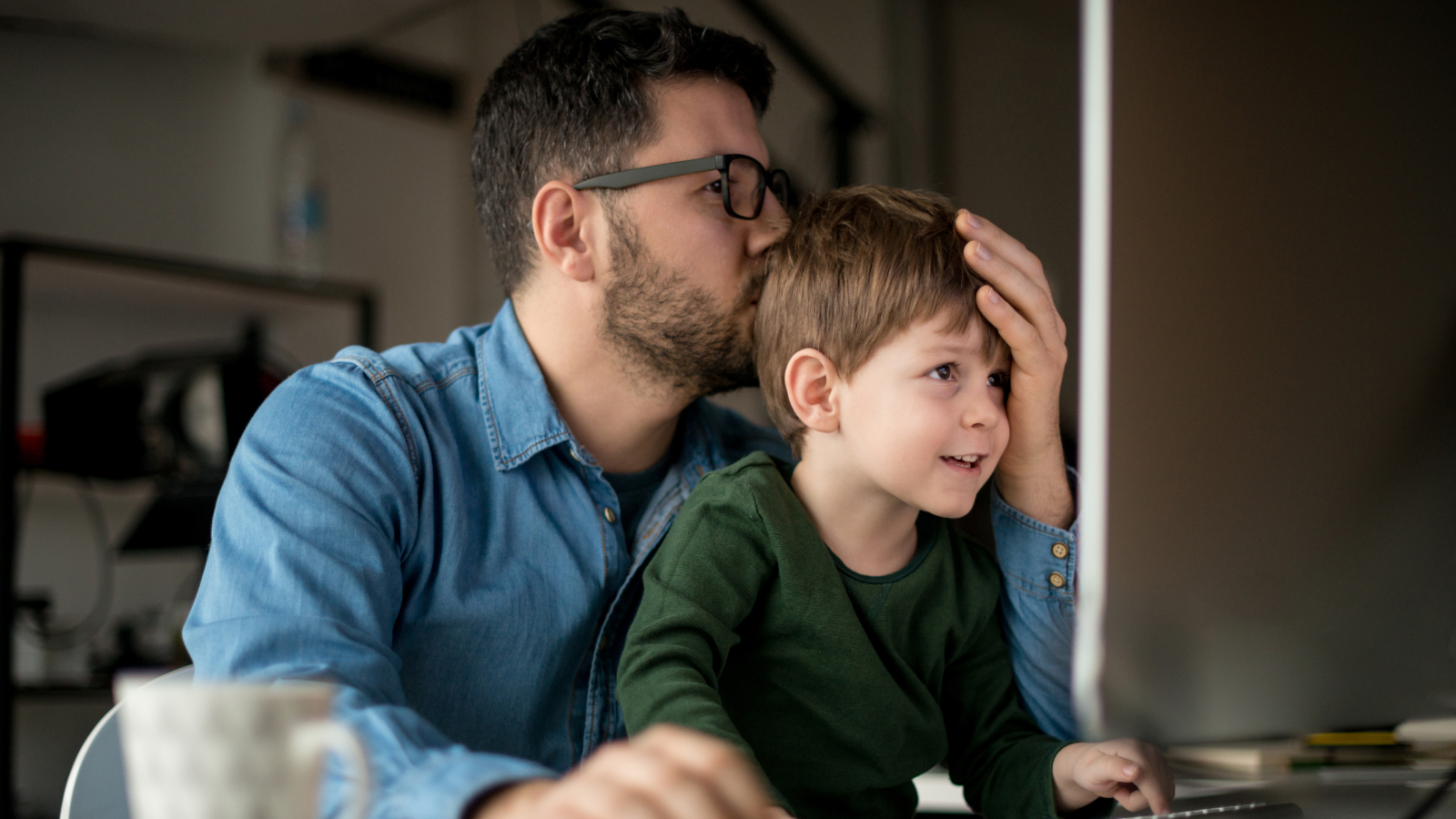 Man working on computer with his child