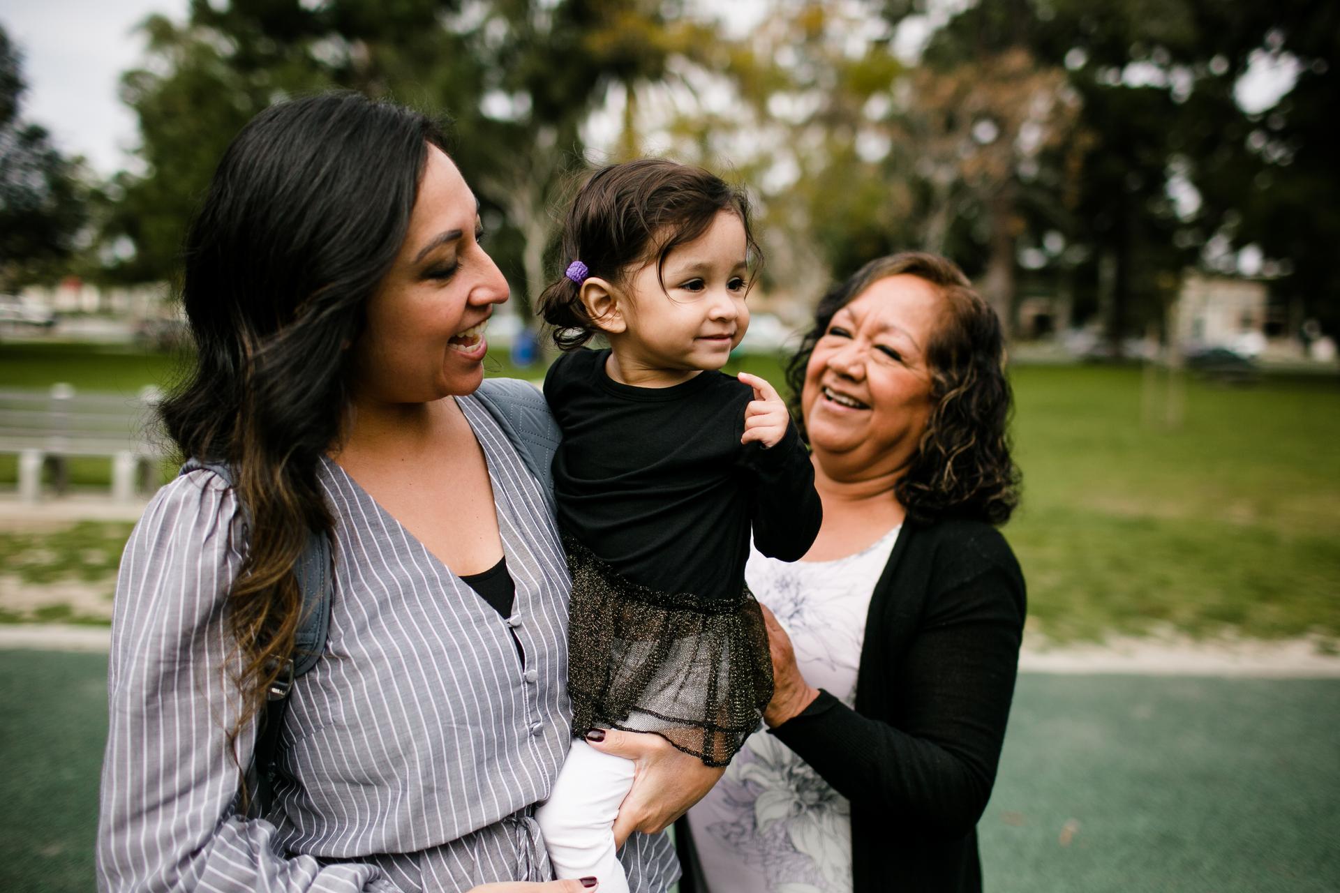 Two women holding a baby girl