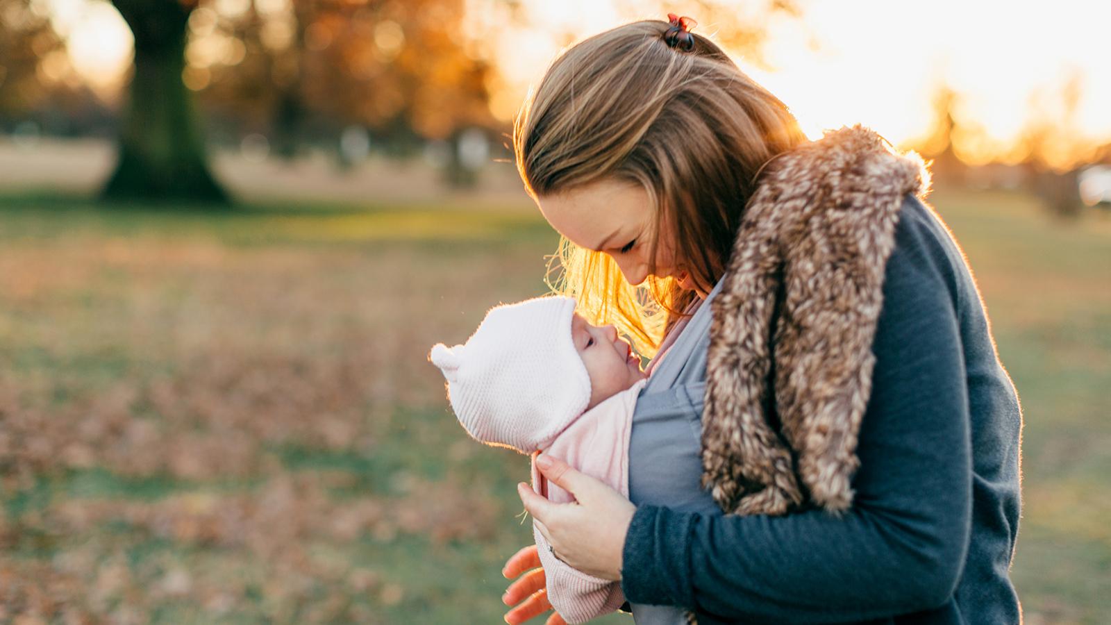 Mother looking at her baby while in a carrier