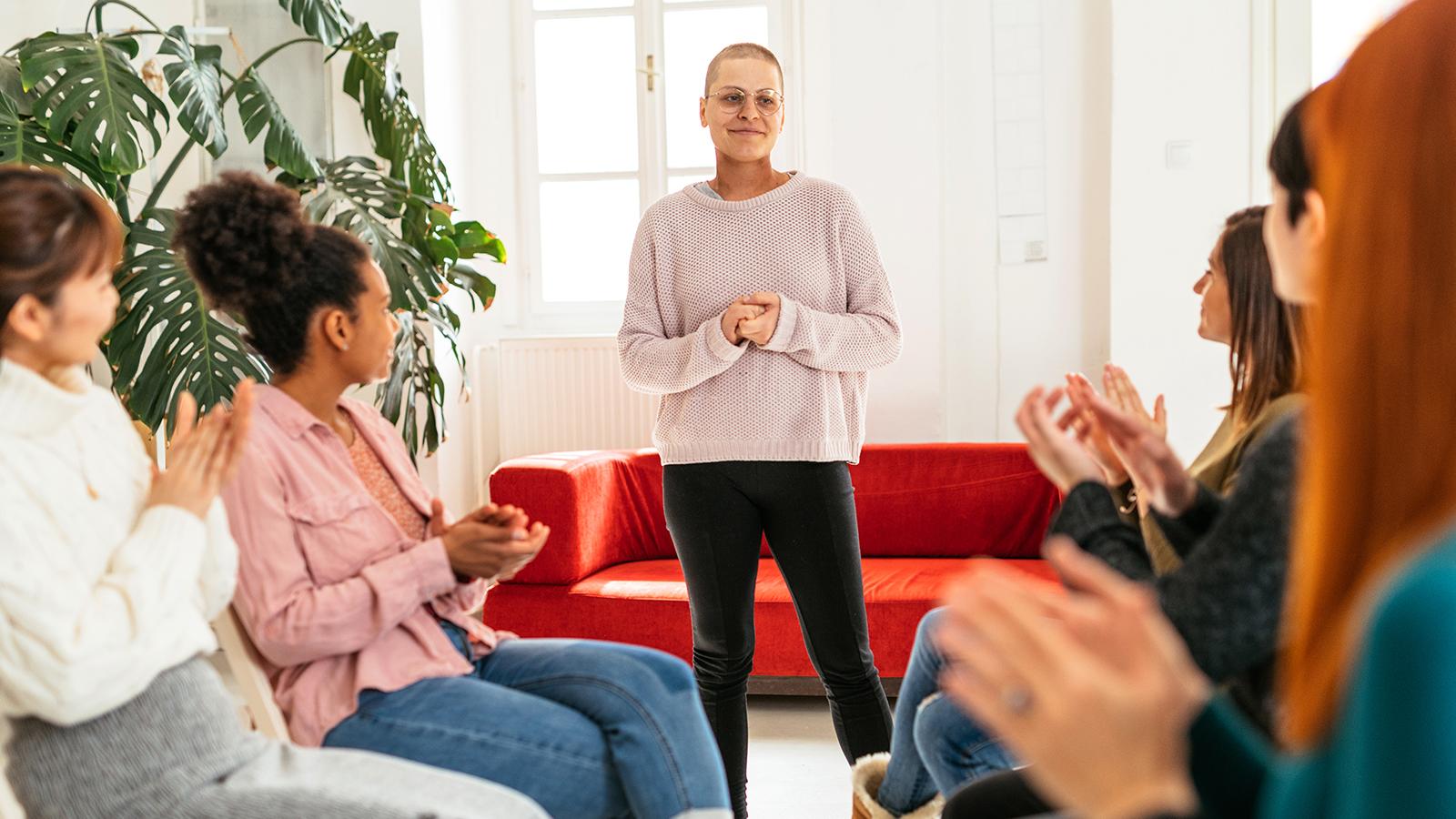 Woman speaking in front of a group