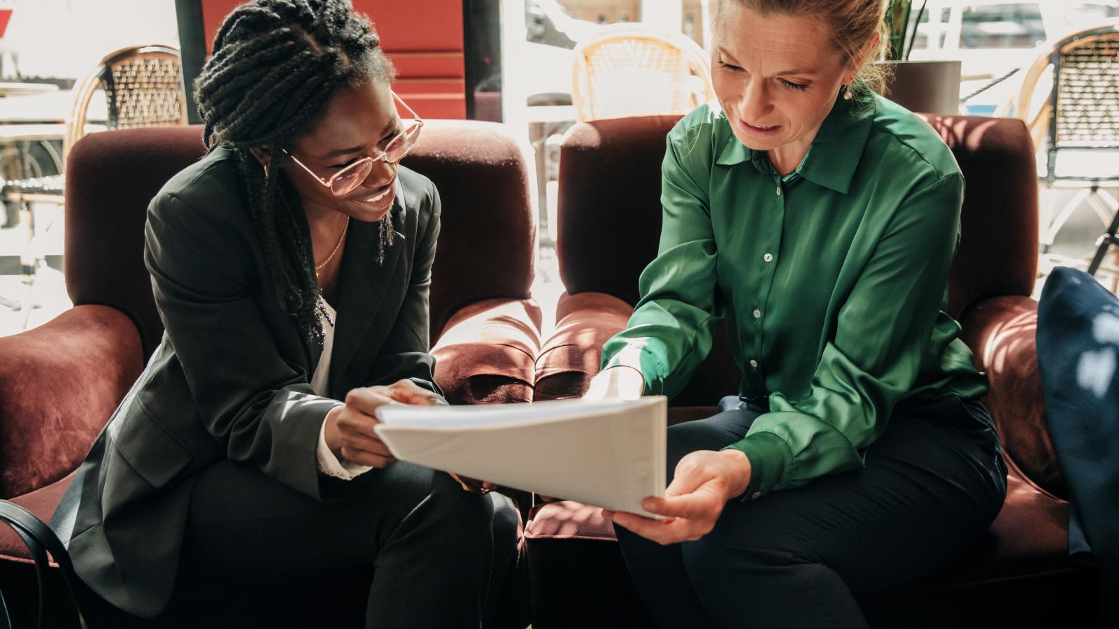 Two women reviewing a business document